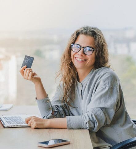 small business owner sitting at desk working on laptop to manage their cash flow