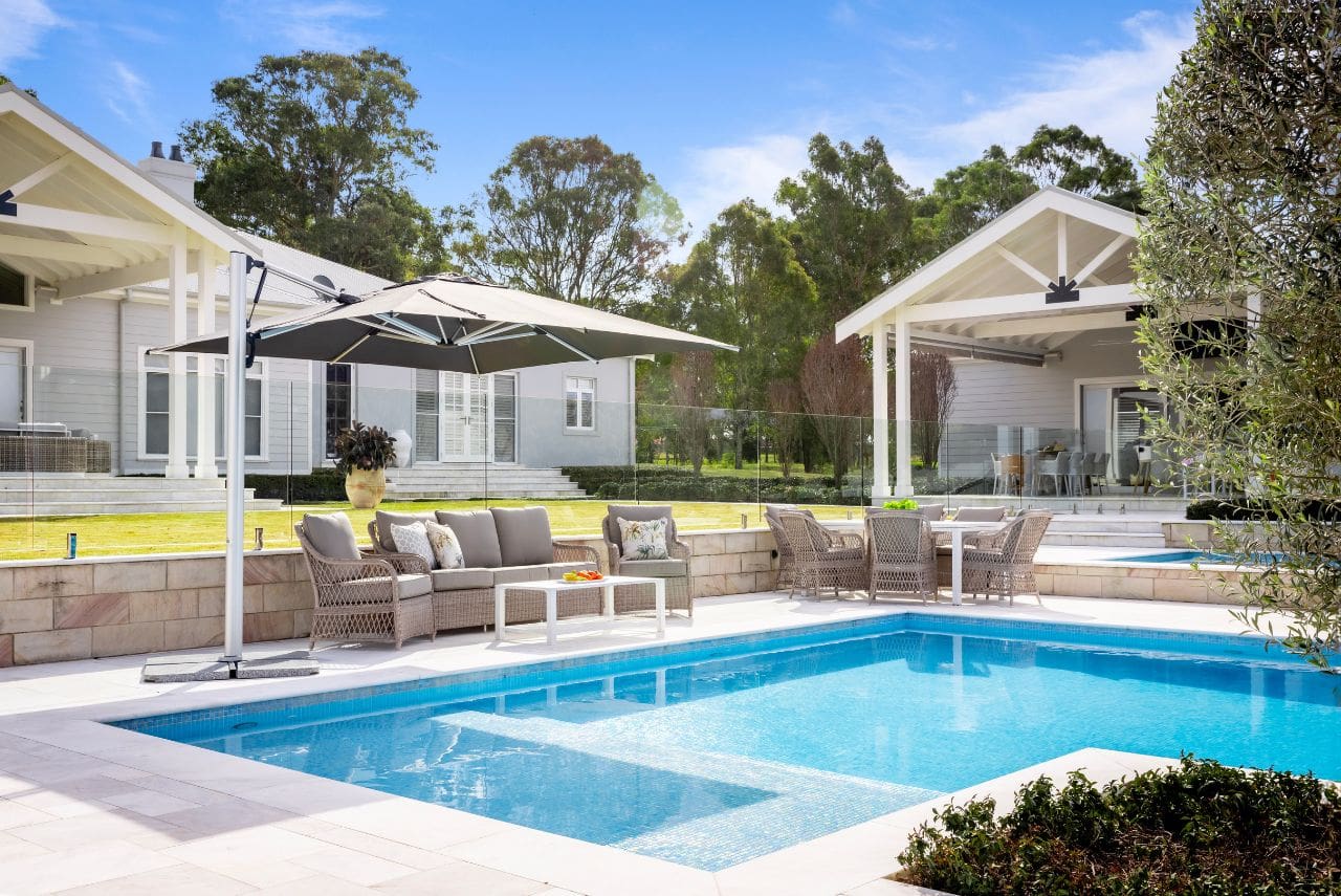 Shelta Australia outdoor setting and umbrella beside pool